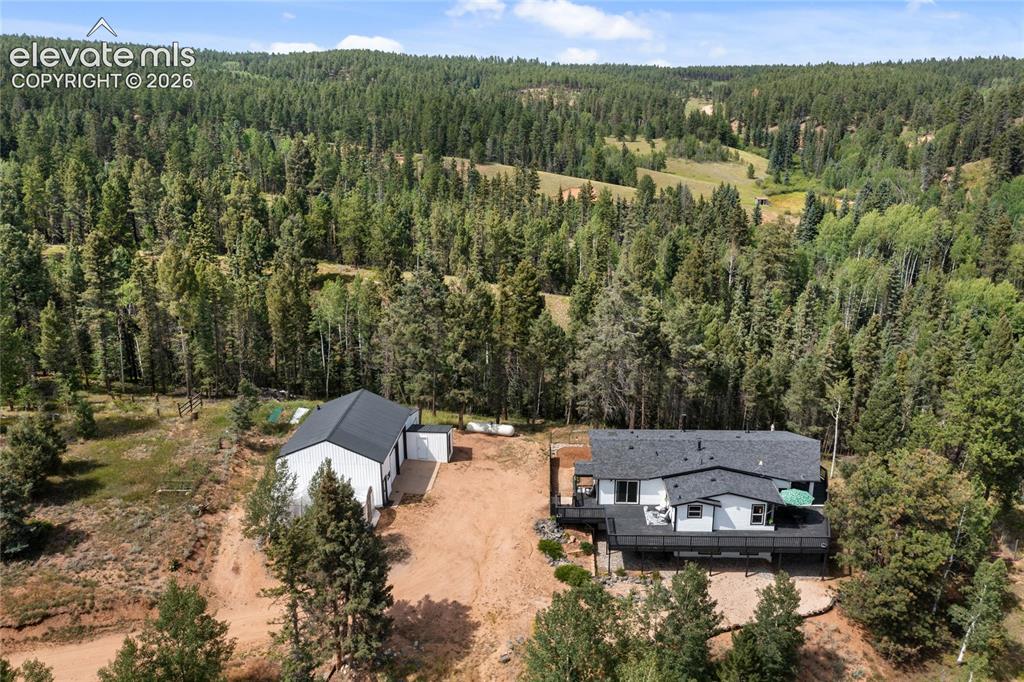 Image 1 of 46: Aerial View, 5.5 acre property extends back behind house & garage