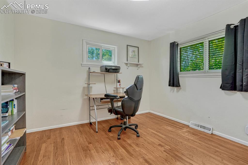 Image 16 of 38: Office featuring baseboards and light wood-type flooring
