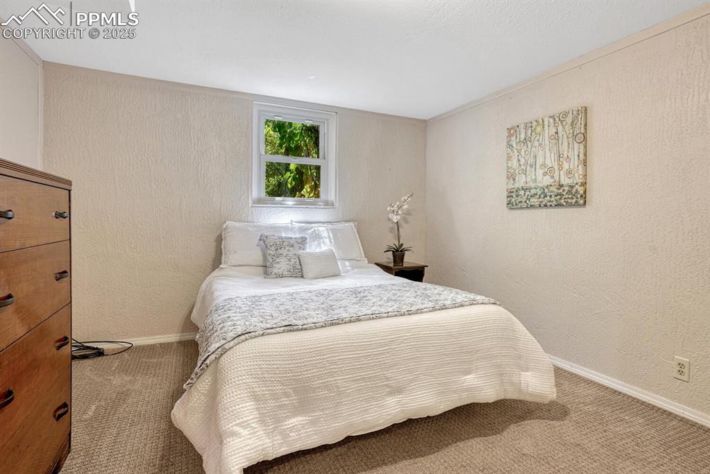 Image 20 of 38: Carpeted bedroom featuring a textured wall