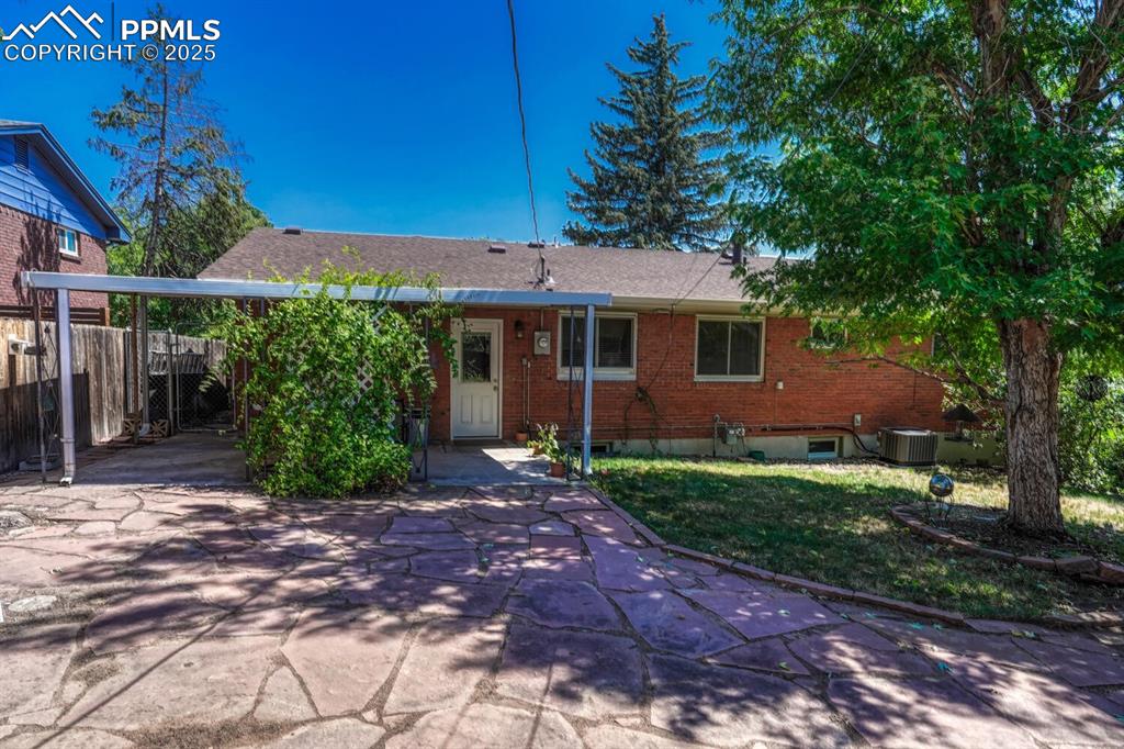 Image 29 of 38: View of front of house featuring brick siding, concrete driveway, a carport