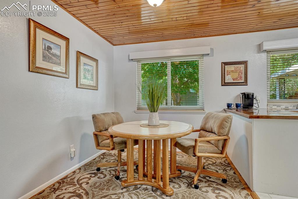 Image 7 of 38: Dining room with wooden ceiling, healthy amount of natural light, and a tex