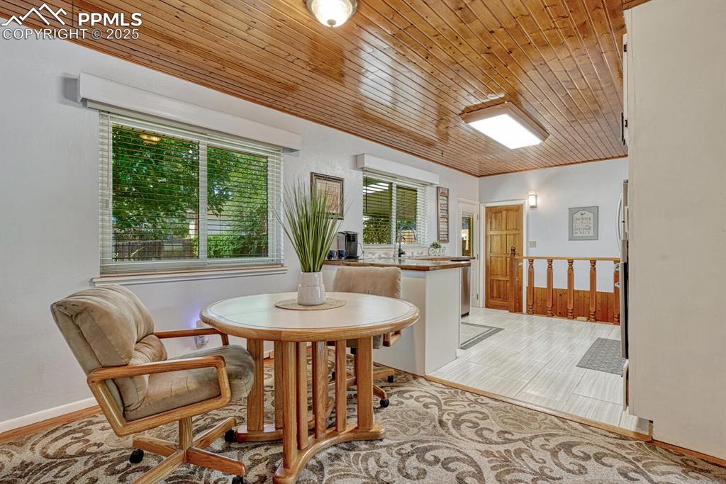 Image 8 of 38: Dining room with wood ceiling and baseboards