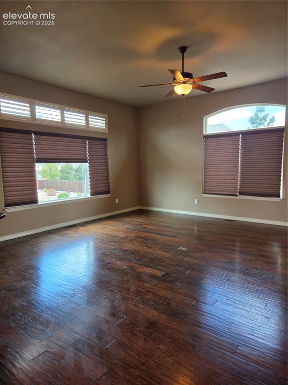 Image 13 of 33: open-Spacious living room featuring wood-finish flooring, a ceiling fan wit