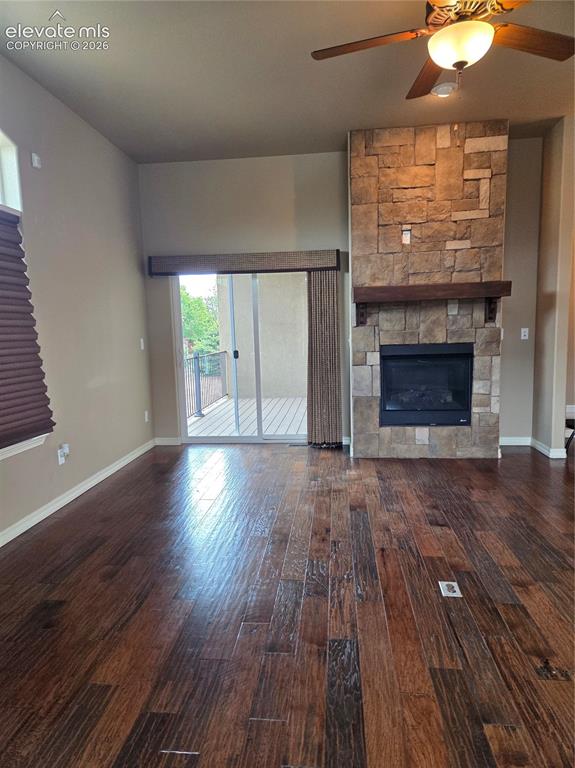 Image 15 of 33: OPEN-Spacious interior featuring wide-plank wood flooring, a stone-clad fir