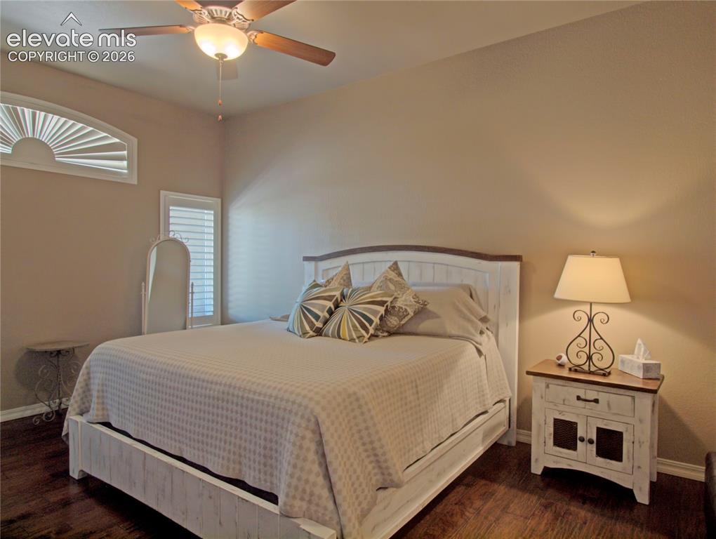 Image 19 of 33: Bedroom featuring wood-finish flooring, a ceiling fan with integrated light