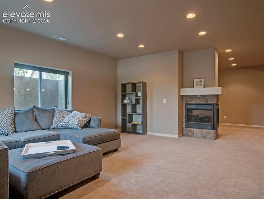 Image 31 of 33: Spacious above grade living area featuring bright light, a two sided firepl