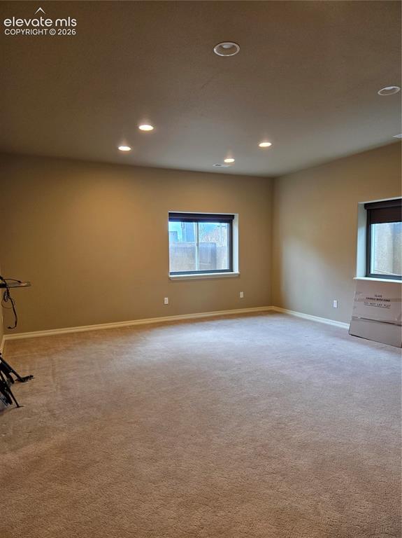 Image 32 of 33: open- Spacious room featuring neutral carpeting, recessed lighting, and two