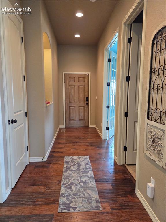 Image 4 of 33: Entryway featuring wood-finish flooring, recessed lighting, and a paneled e