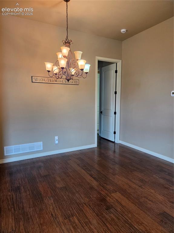 Image 8 of 33: OPEN- Formal dining space ,master bedroom entry door