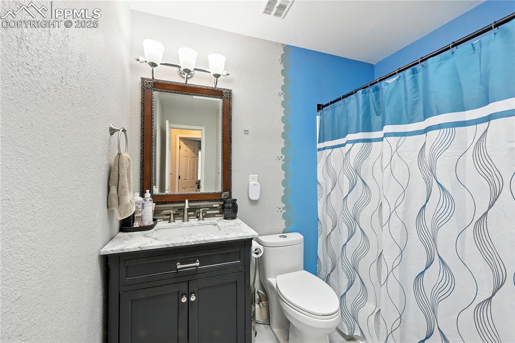 Image 13 of 40: Upstairs hallway bathroom