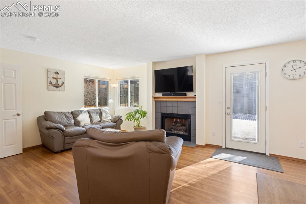 Image 4 of 26: Cozy gas fireplace and walk out to patio