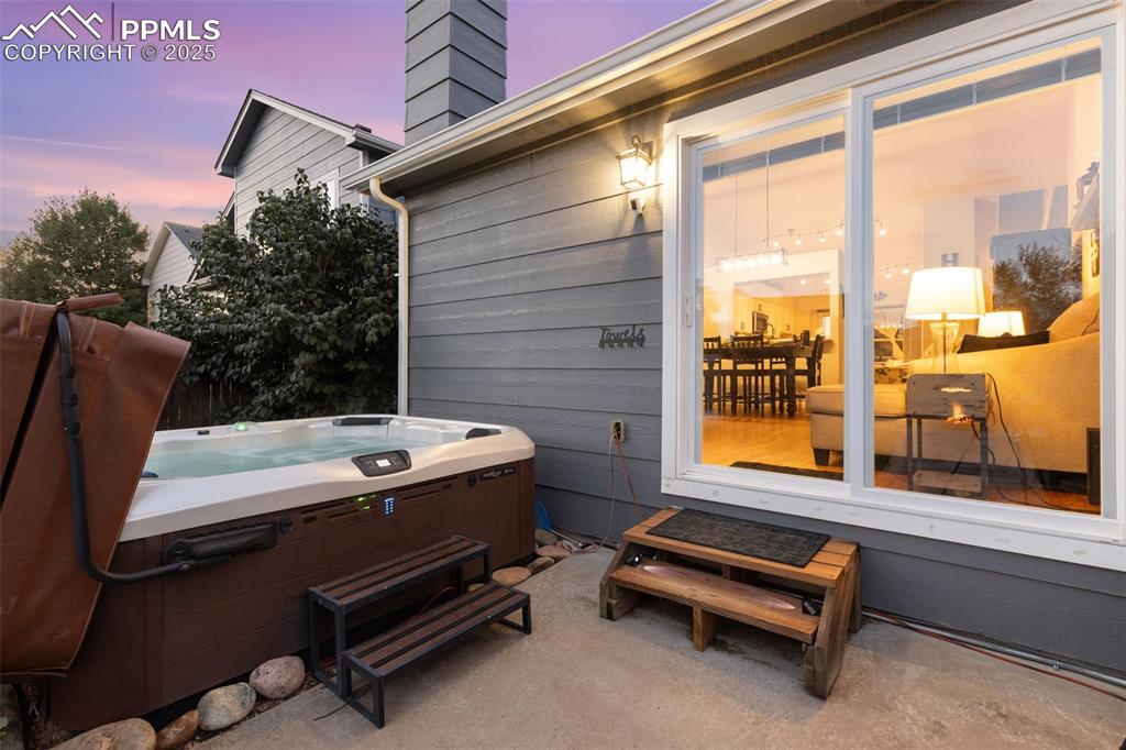 Image 13 of 39: View of patio / terrace with a hot tub