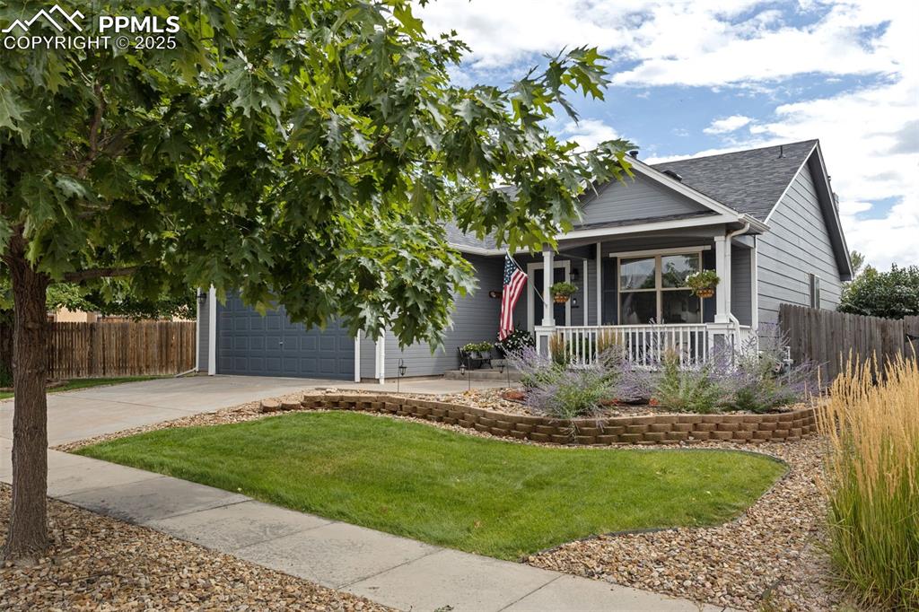Image 15 of 39: View of front of property with covered porch, driveway, and a shingled roof