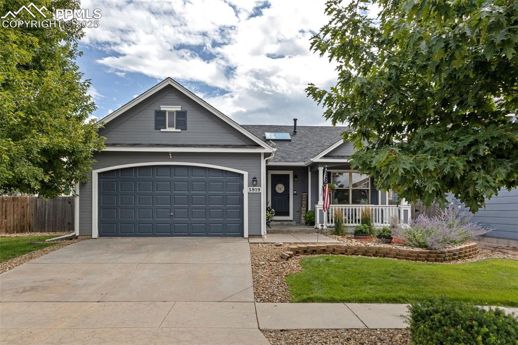 Image 16 of 39: View of front of property with concrete driveway and a porch