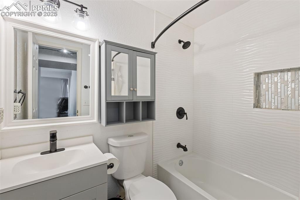Image 32 of 39: Full bath with bathing tub / shower combination and vanity