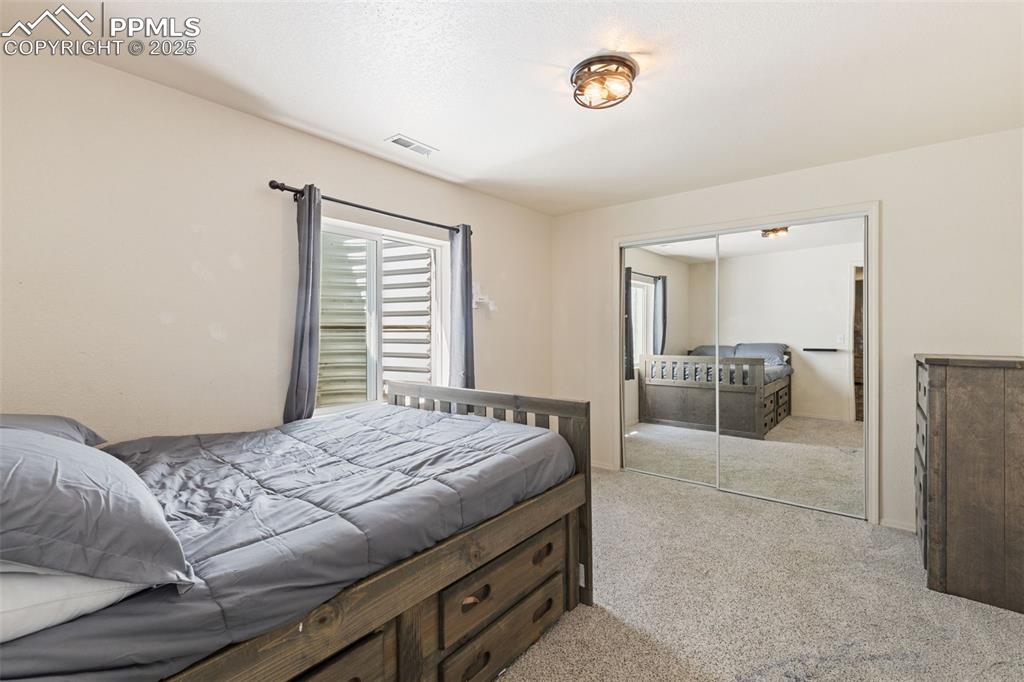 Image 35 of 39: Bedroom with carpet flooring and a closet