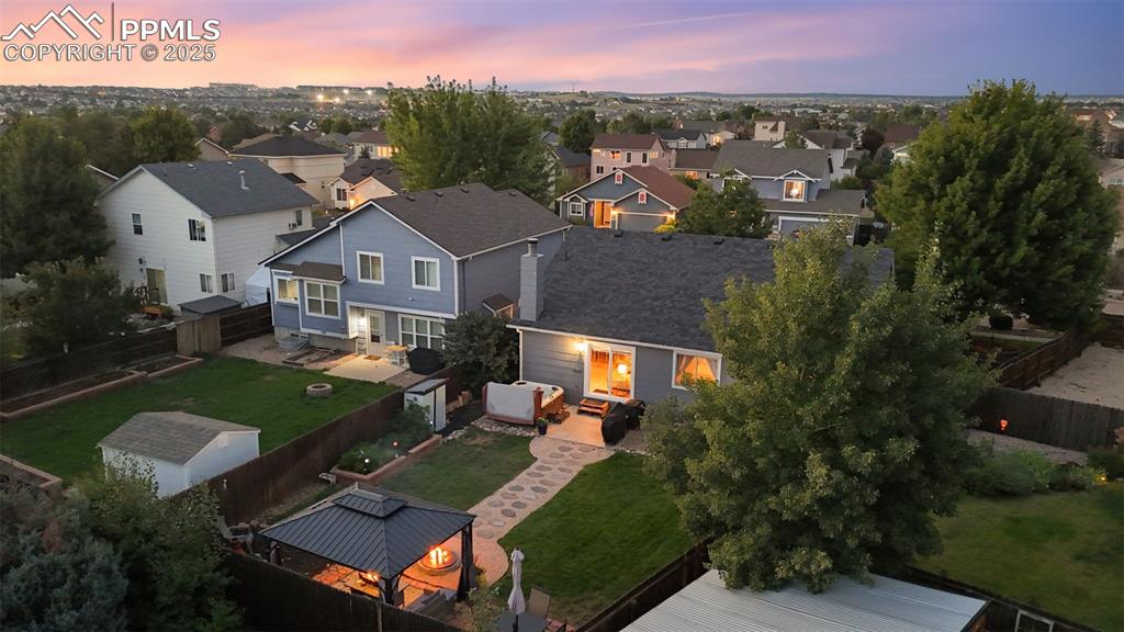 Image 4 of 39: Aerial view at dusk of a residential view