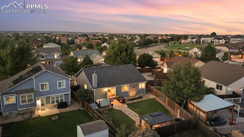 Image 5 of 39: Aerial view at dusk of a residential view