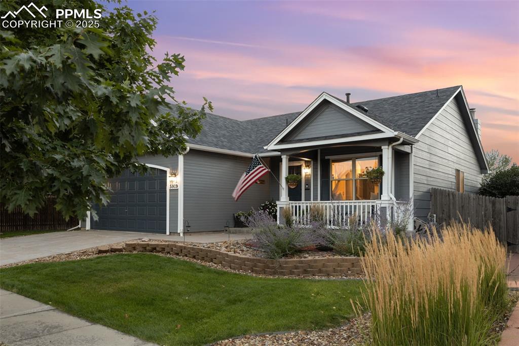 Image 8 of 39: Ranch-style house with concrete driveway, a shingled roof, an attached gara