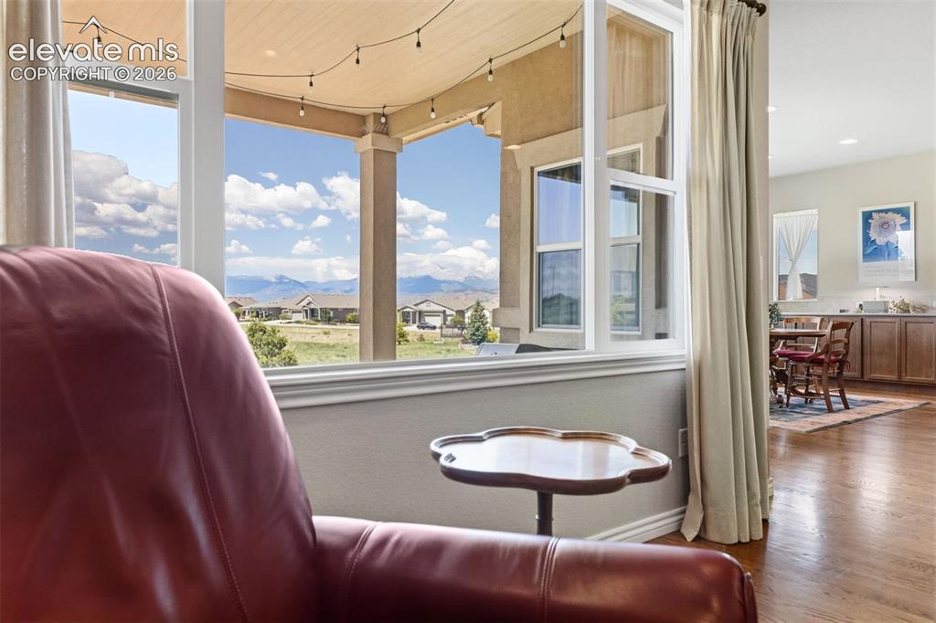 Image 11 of 49: Relax in the living room while enjoying unobstructed views of Pikes Peak