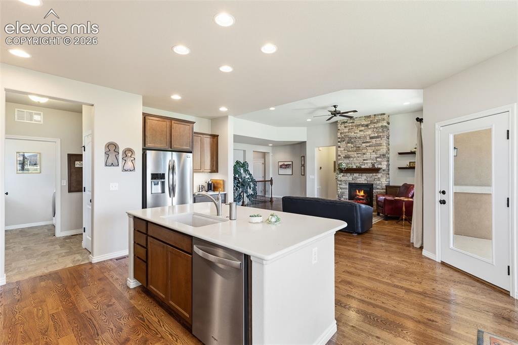 Image 14 of 49: View of open floor plan - from the kitchen to patio, living room and bedroo