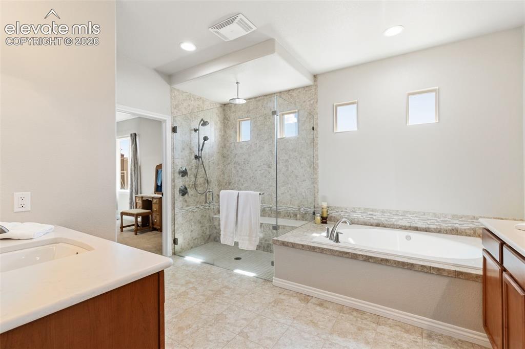 Image 22 of 49: En suite primary 5-piece spa-inspired bathroom