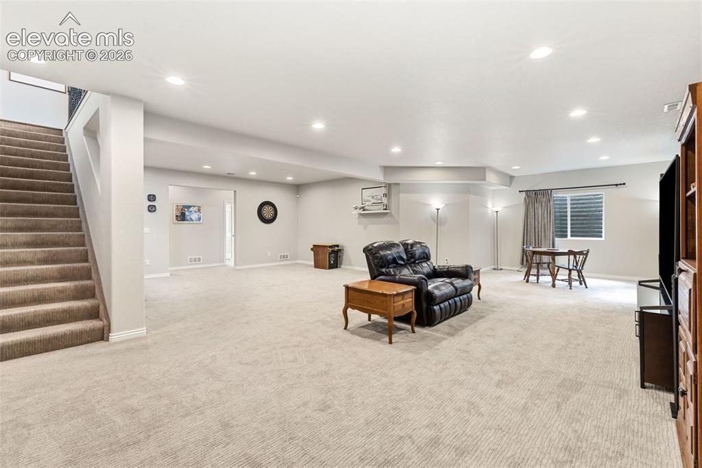 Image 29 of 49: Large rec room area in the basement