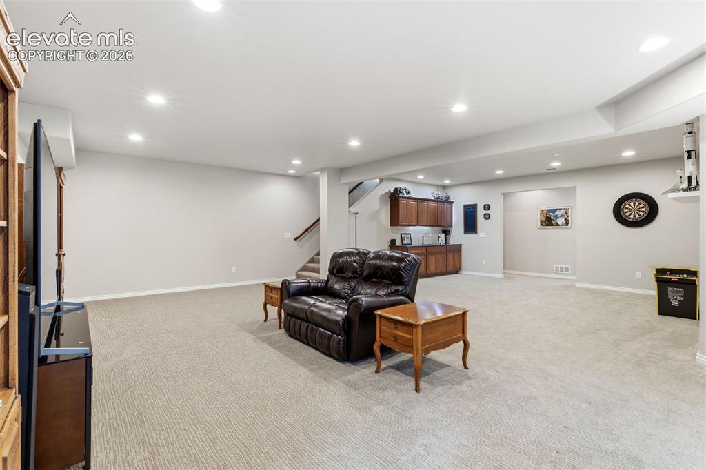 Image 30 of 49: Large rec room area in the basement