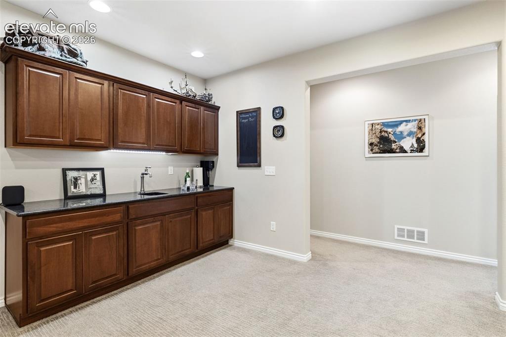 Image 33 of 49: Wet bar in basement