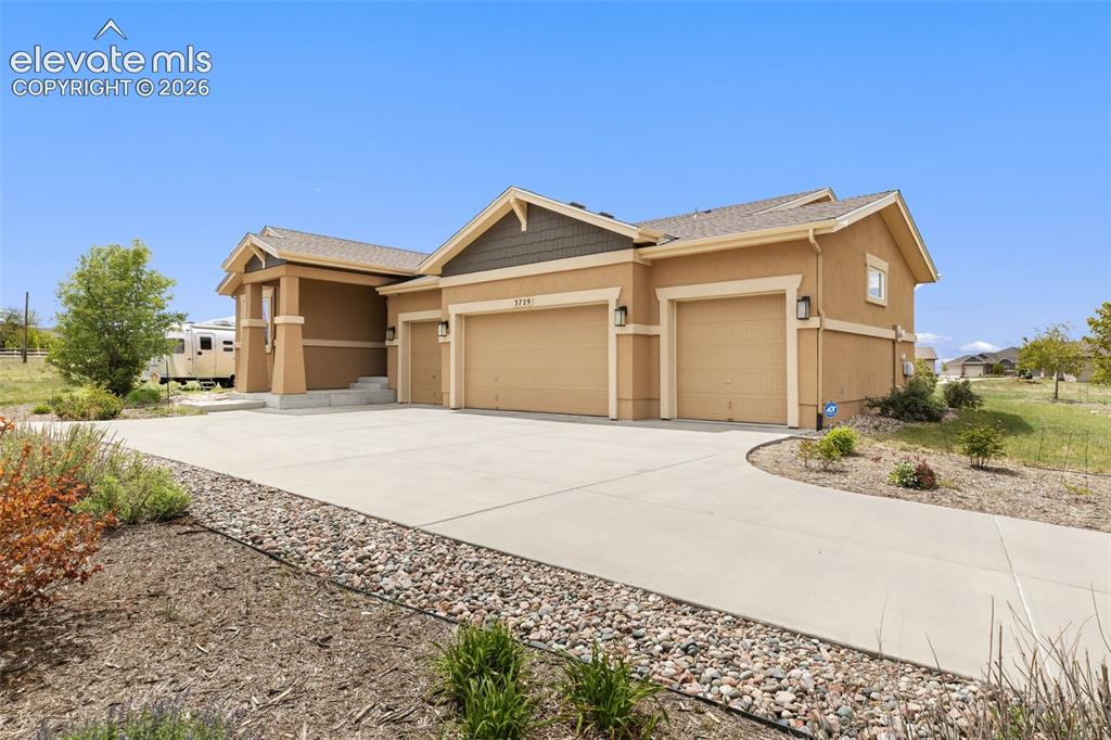 Image 39 of 49: Front of house with 4 car garage