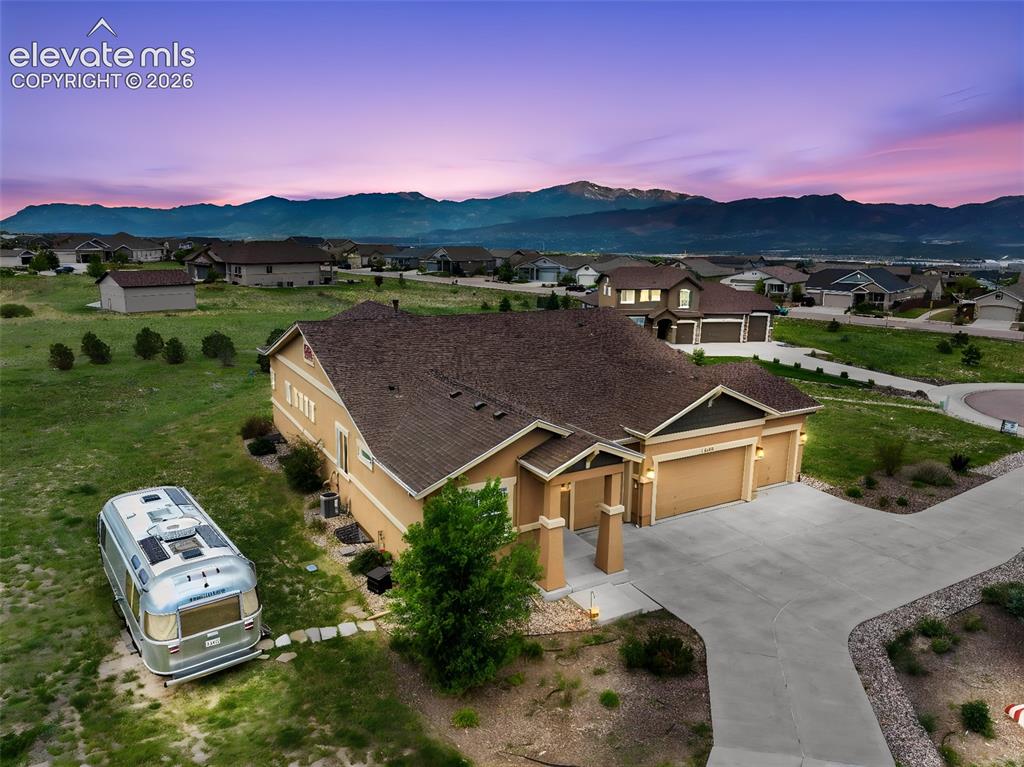 Image 41 of 48: Aerial view of property at sunset
