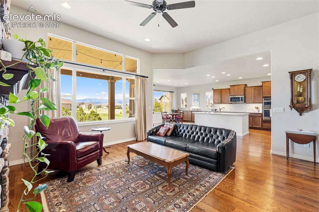 Image 7 of 49: Open floor plan of living room, kitchen and eat-in area featuring mountain