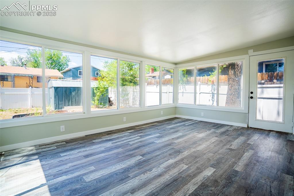 Image 11 of 24: Beautiful sunroom with access off kitchen and back yard access