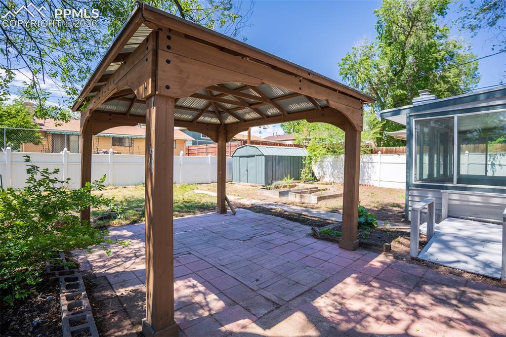Image 22 of 24: Gazebo great for shaded entertainment. Bonus shed located behind