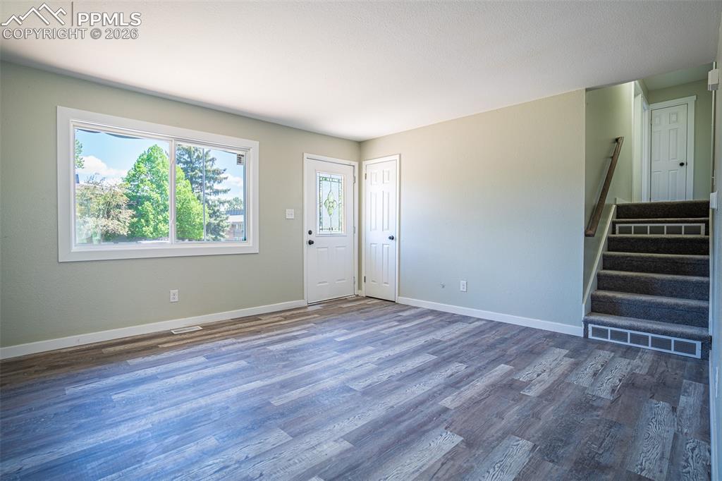Image 7 of 24: Front door entry showing stairs to bedrooms