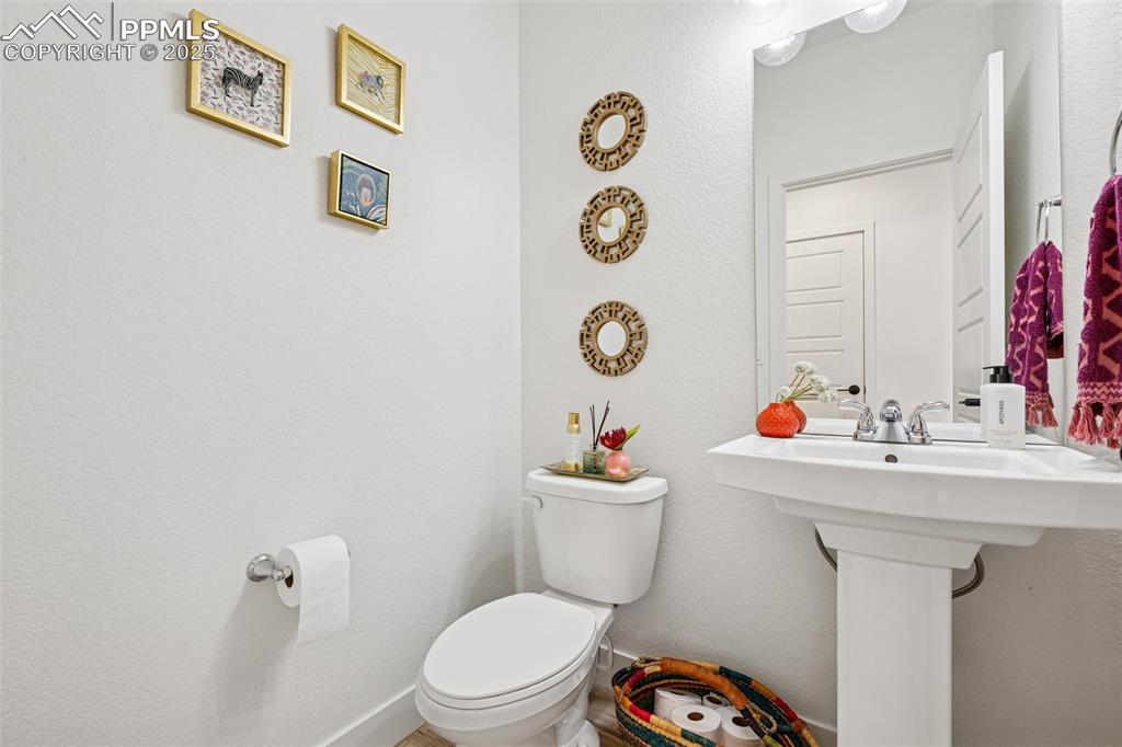 Image 12 of 43: Bathroom featuring a textured wall and toilet