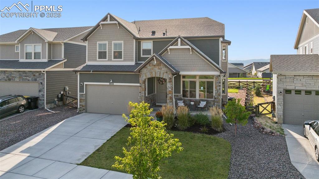 Image 3 of 43: Craftsman inspired home featuring a residential view, stone siding, a shing