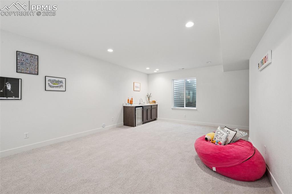 Image 38 of 43: Rec room with light colored carpet and recessed lighting