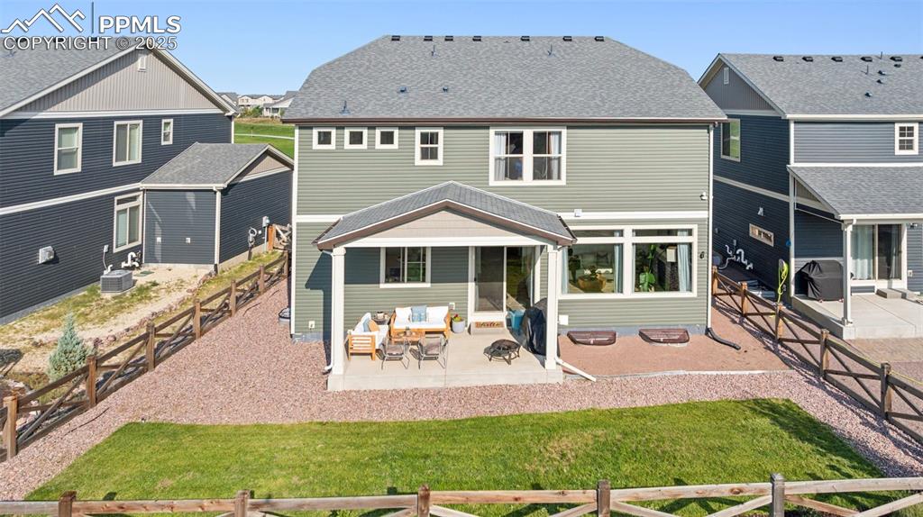 Image 40 of 43: Rear view of house featuring a patio, a fenced backyard, a residential view