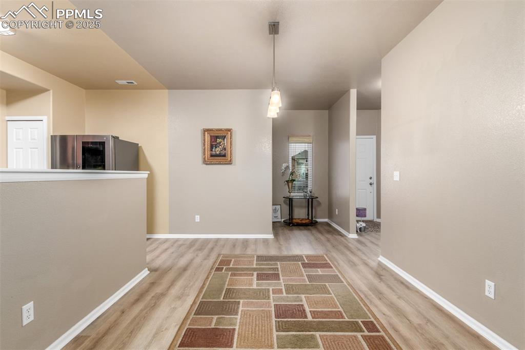 Image 5 of 29: Dining room opens to both the kitchen and the living room 