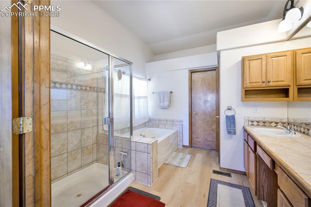 Image 15 of 30: Primary bathroom and walk in closet