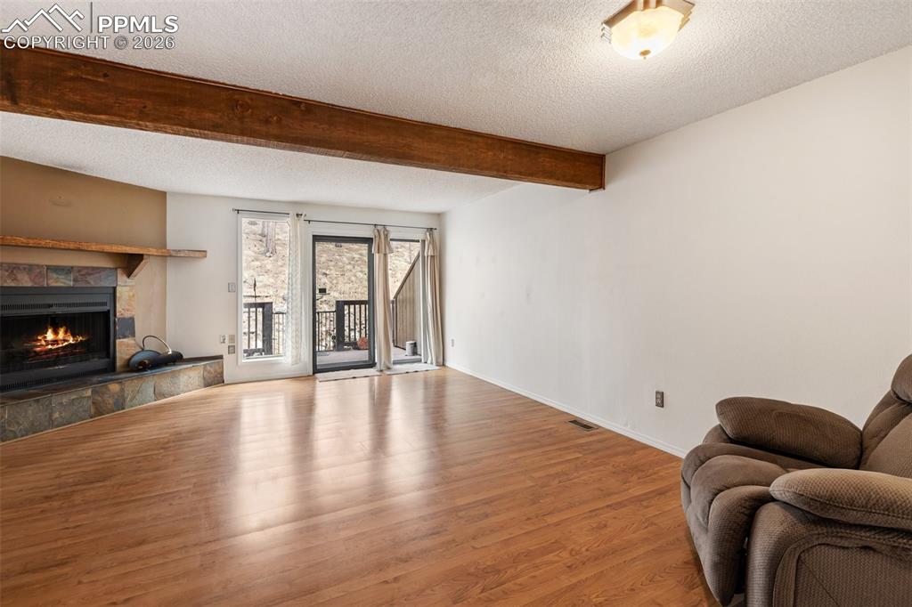 Image 2 of 34: Living Room with fireplace and back porch.