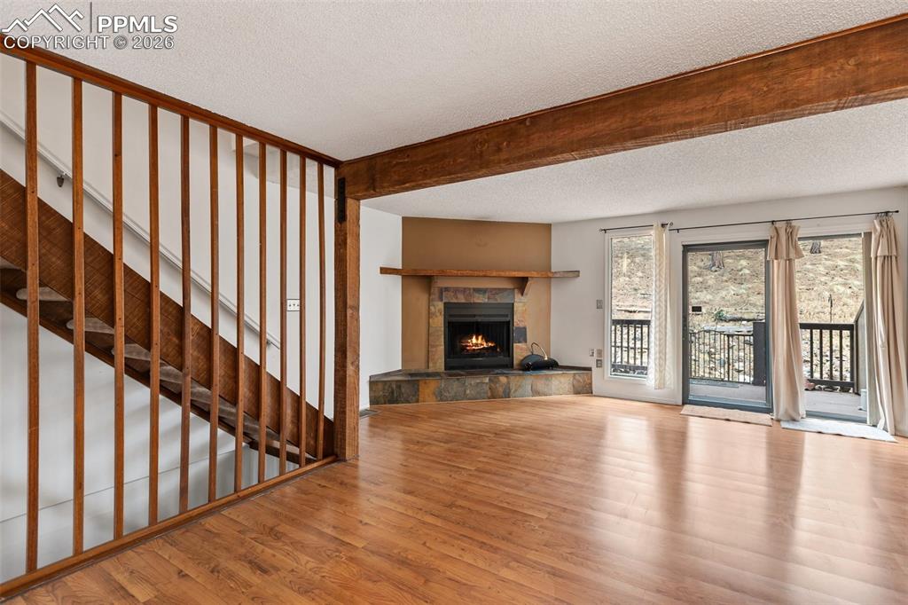 Image 3 of 34: Living Room with fireplace and back porch.