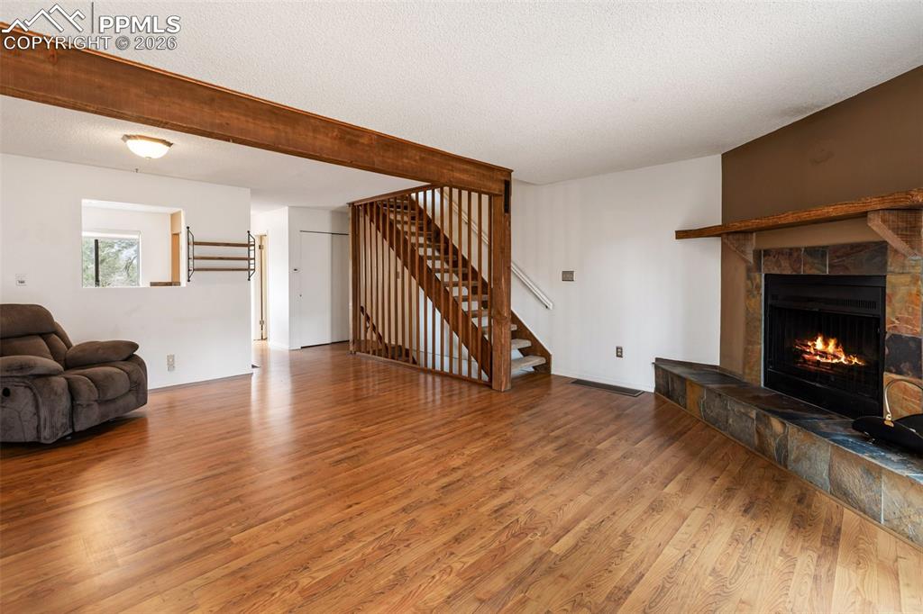 Image 5 of 34: Living Room with fireplace and back porch.
