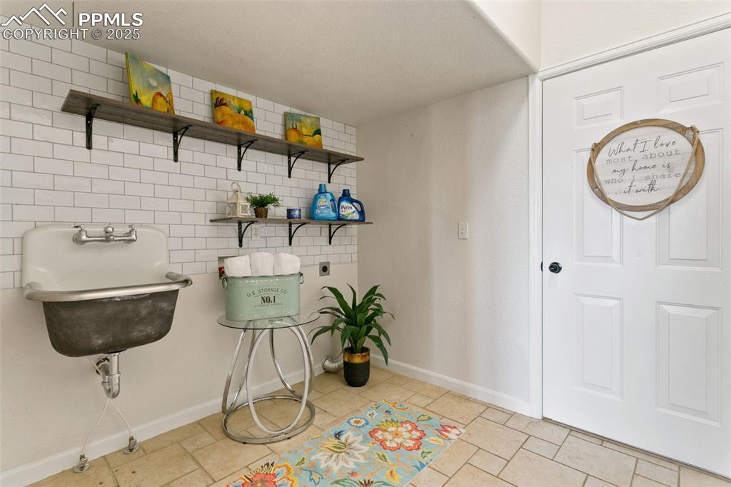 Image 23 of 44: Laundry room with electric dryer hookup and baseboards