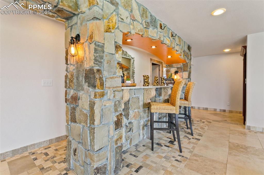 Image 30 of 44: Indoor bar featuring baseboards and recessed lighting
