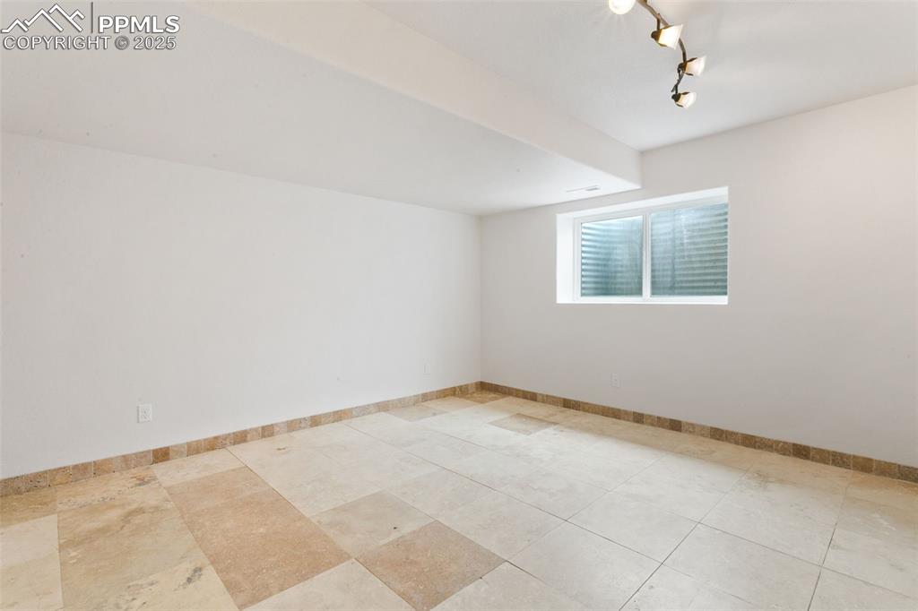 Image 34 of 44: Spare bedroom with baseboards and track lighting