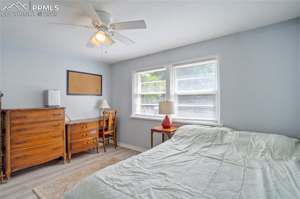 Image 16 of 28: Bedroom featuring wood finished floors and ceiling fan
