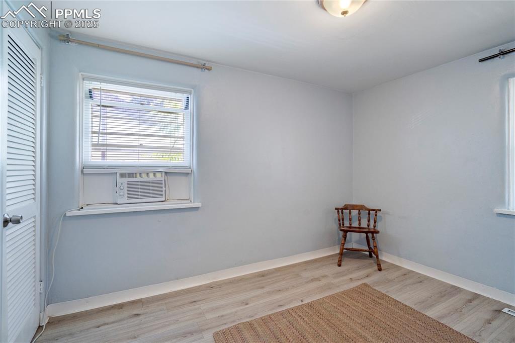 Image 18 of 28: Unfurnished room with wood finished floors and baseboards