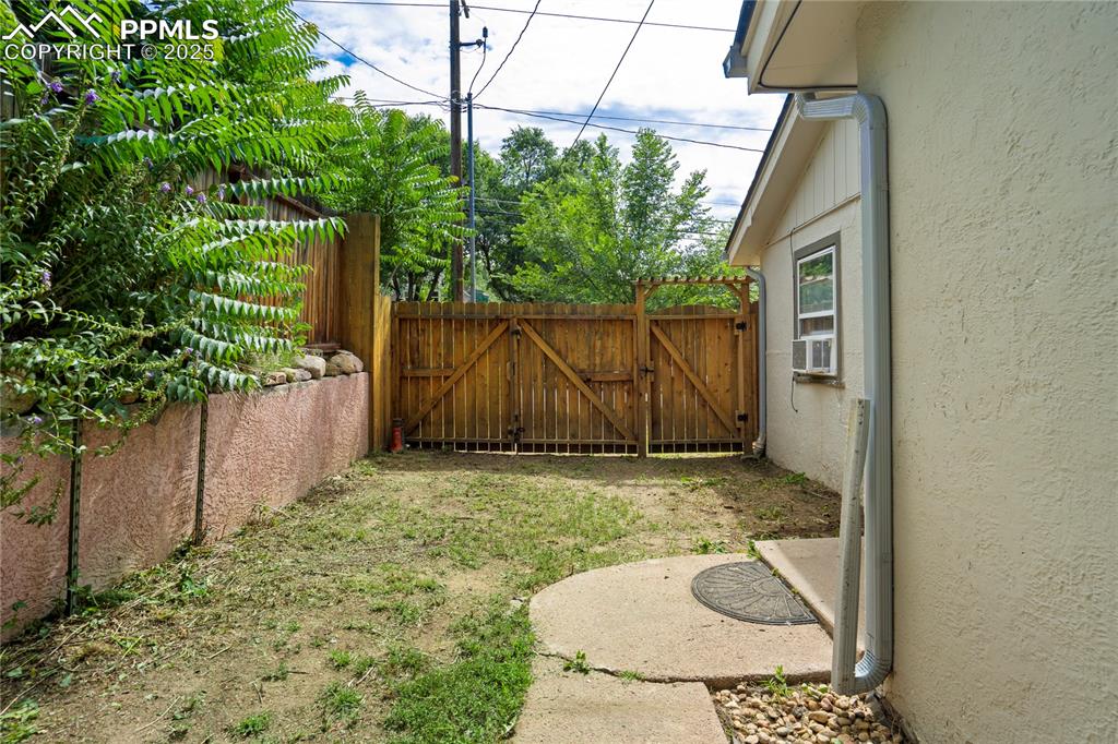 Image 23 of 28: View of yard featuring a gate